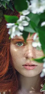 Portrait of a woman surrounded by green leaves and white flowers.