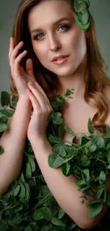 Portrait with lush green leaves on a dark background.