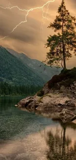 Majestic tree by lake with lightning and mountains in the background.