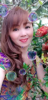 Woman in colorful dress surrounded by vibrant garden flowers.