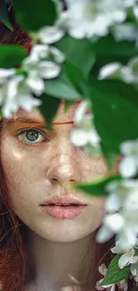 Portrait among green leaves and white flowers in vibrant nature wallpaper.