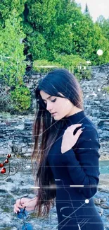 Woman in black dress stands by a rocky stream surrounded by greenery.