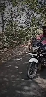 Person riding a motorbike through a forest path