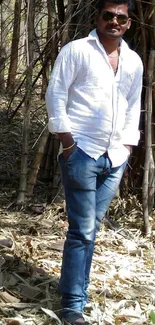 Person standing in serene bamboo forest setting.