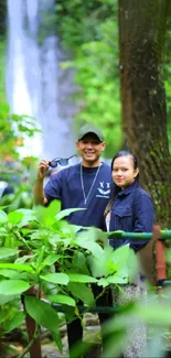 Friends enjoying a nature walk with waterfall in the background.