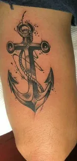 Detailed anchor tattoo on arm, nautical design.