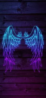 Vibrant neon angel wings on wood background.