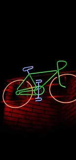 Neon bicycle art on a dark brick wall background.