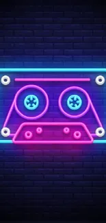 Vibrant neon cassette tape on dark brick wall.