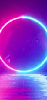 Vibrant neon circle on reflective floor with pink and blue hues.