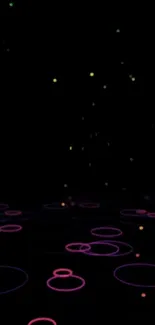 Neon circles glowing on a black background.