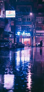 Neon-lit urban street reflecting lights at night.