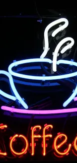 Vibrant neon coffee cup sign with colorful lights on black background.