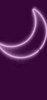 Purple neon crescent moon over dark background.