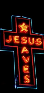 Neon cross with 'Jesus Saves' text glowing in darkness.