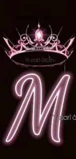 Neon letter M with crown on black background.