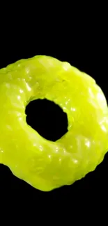 Glowing neon yellow doughnut on black background