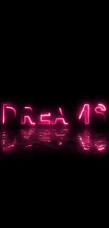 Neon pink 'Dreams' text on a black background with reflection.