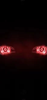 Neon red eyes glowing on a dark, black background wallpaper.