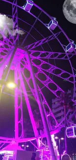 Neon Ferris wheel glowing under a moonlit sky.