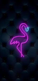 Neon pink flamingo on a dark quilted background wallpaper.