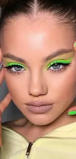 Closeup of a model with neon makeup and nails.