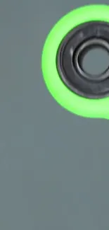 Neon green fidget spinner on dark background.