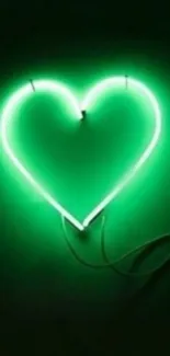 Neon green heart glowing on dark background wallpaper.