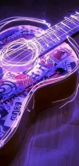 Neon glowing guitar with colorful graphics and purple lighting.