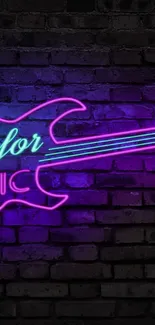 Neon pink guitar sign on a brick wall background.