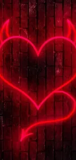 Neon heart with horns on dark brick wall background.