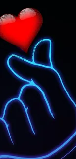 Neon hand holding a glowing red heart on black background.