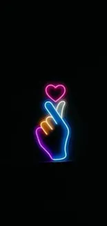 Neon hand gesture with heart in vibrant colors over black background.