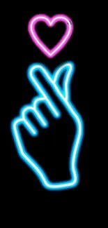 Neon hand gesture with heart glowing in pink and blue on black background.