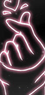 Neon pink hand gesture with heart on a black background.