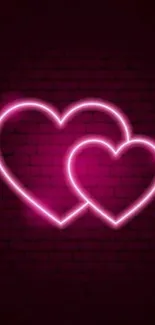 Neon hearts glowing on dark brick background.