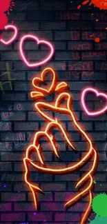 Neon art featuring a love hand gesture with hearts on a colorful graffiti wall.