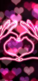 Neon hand heart shape on black background.