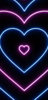 Neon heart wallpaper with pink and blue light pattern.