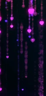 Neon heart lights on a dark mobile wallpaper.