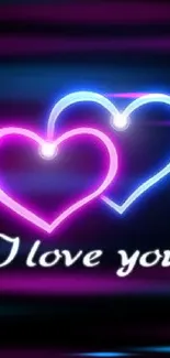 Neon heart wallpaper with 'I love you' text in blue and pink glow.