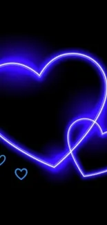 Glowing neon blue heart on dark wallpaper.