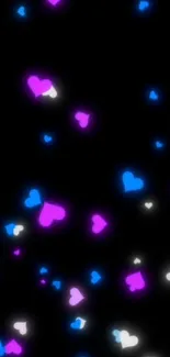 Neon hearts in pink, blue, and white on a black phone wallpaper.