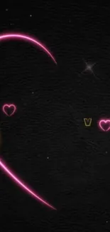 Neon heart with pink and gold glow on a dark background.