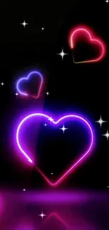 Colorful neon heart design on a black background, glowing in vibrant tones.