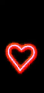 Glowing neon red heart on a black background.