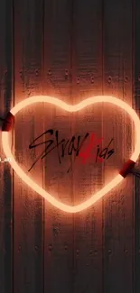 Neon heart design on wooden background.