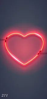 Neon heart glowing on dark background with red light.