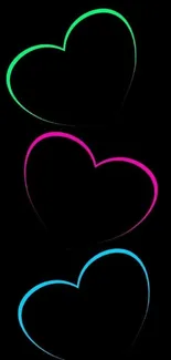 Mobile wallpaper with glowing neon hearts on black background.