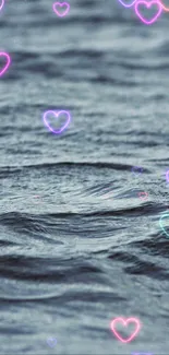 Serene ocean with neon hearts floating above the waves.